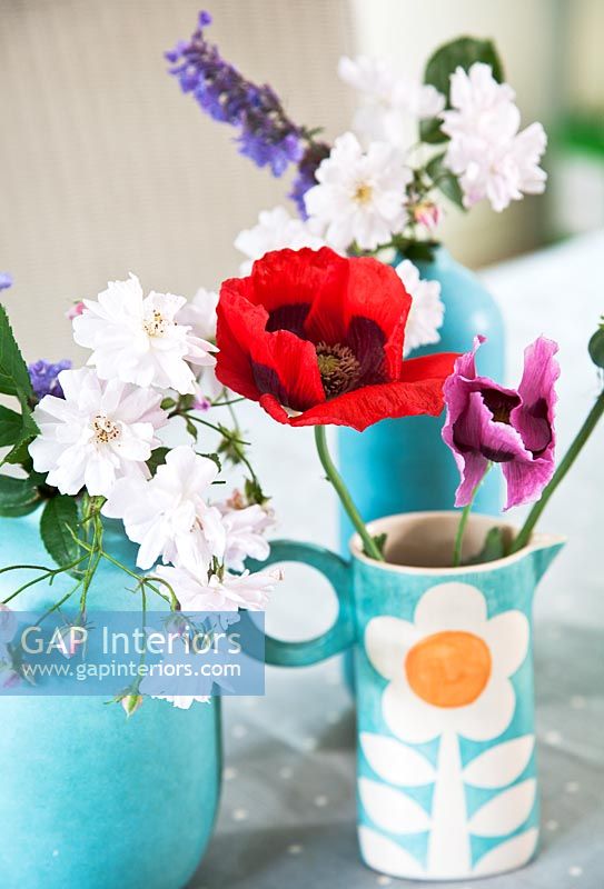 Flowers in turquoise jugs