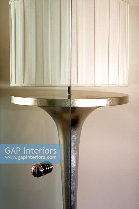 Modern lamp reflected in cabinet door