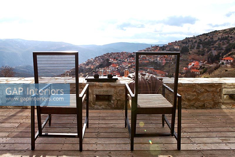 Traditional balcony with modern chairs and scenic view
