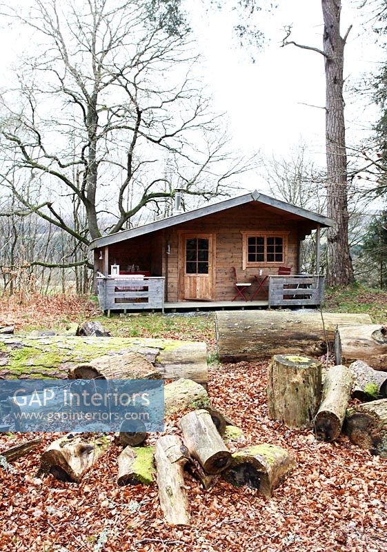 Wooden cabin in woodland garden