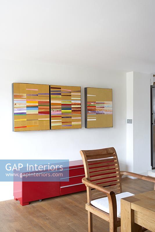 Abstract painting above contemporary sideboard