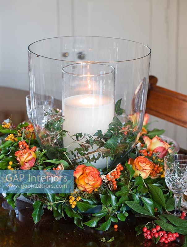 Christmas centre piece of Roses, berries and seasonal foliage