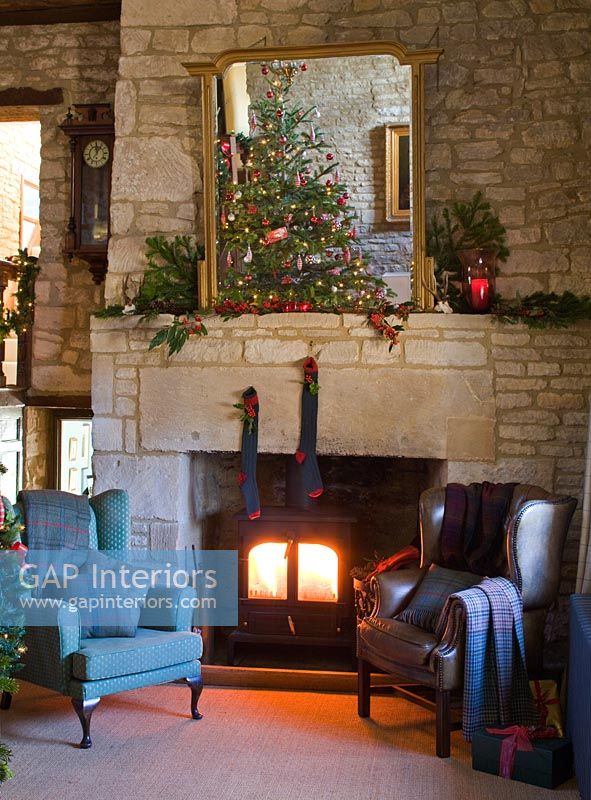 Cotswold stone fireplace decorated for Christmas