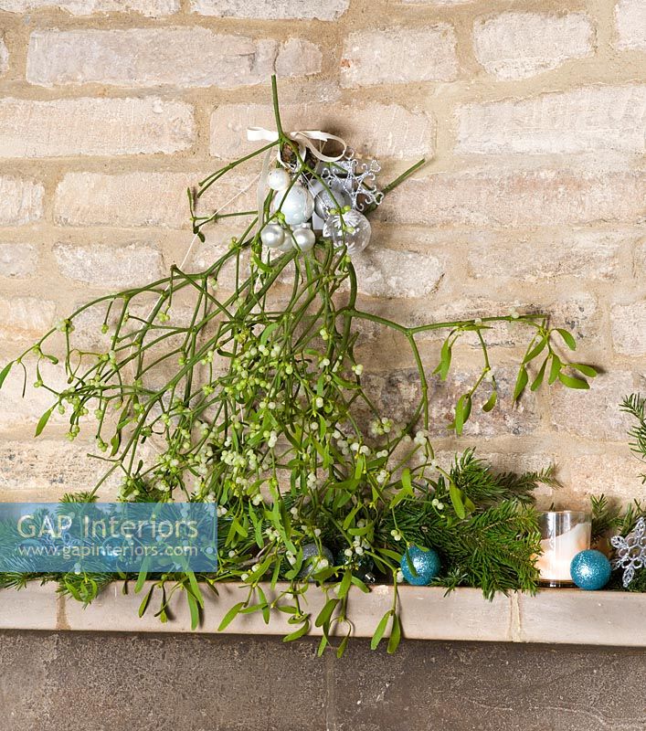 Cotswold stone mantlepiece decorated with Mistletoe