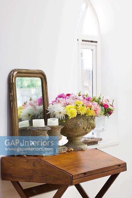 Wooden desk with flowers and candles