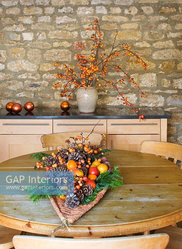 Christmas arrangement of Fir cones, fruit and berries on wooden table