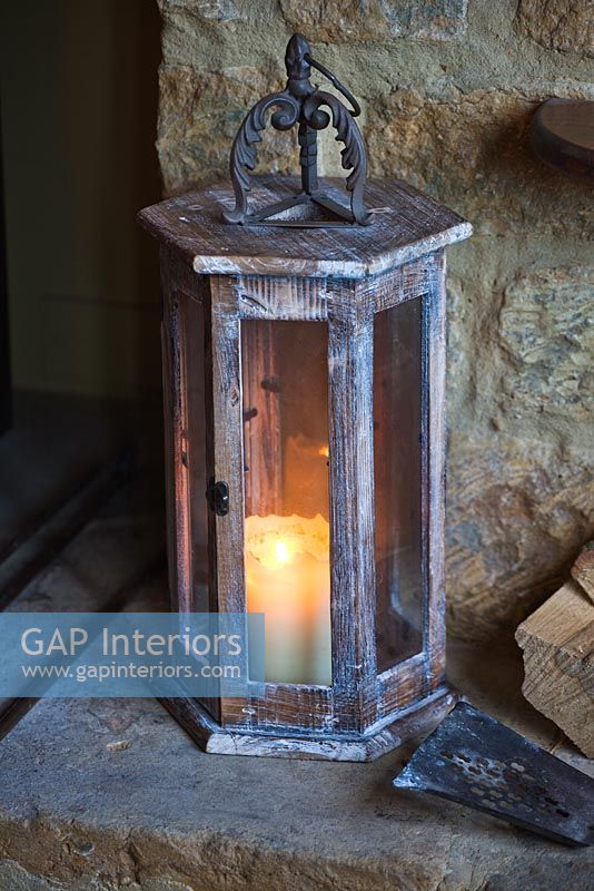 Wooden lantern on stone hearth