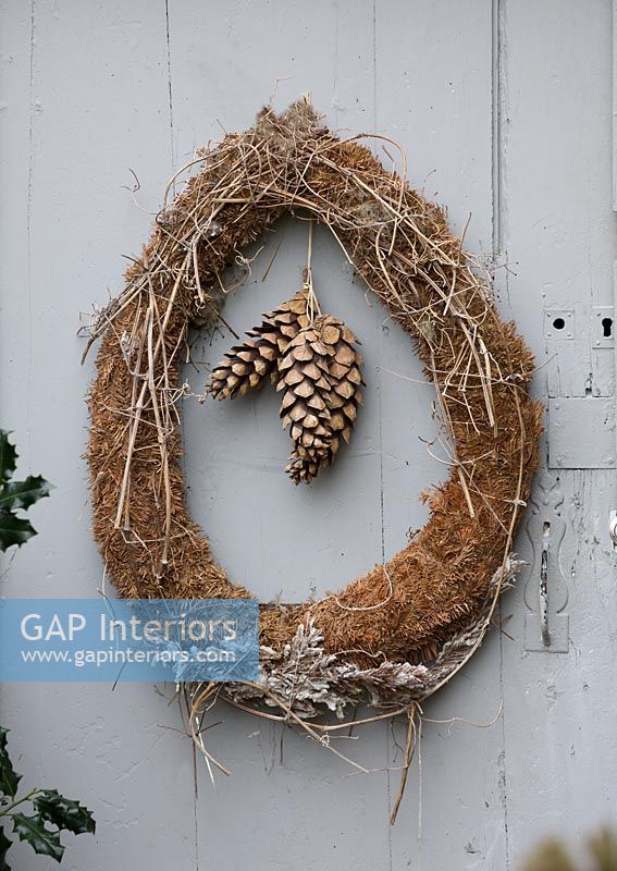 Simple Christmas wreath of moss, twigs and cones