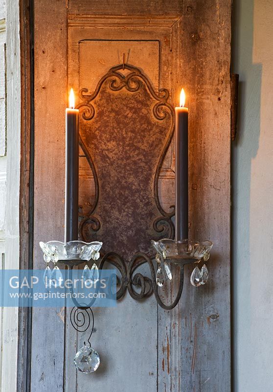 Decorative candle sconces on shutter