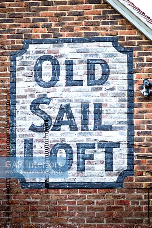 Painted sign on red brick wall