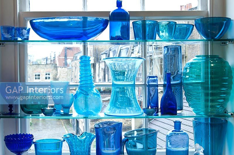 Display of blue glassware at window