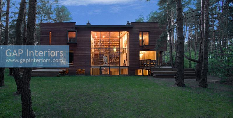 Contemporary timber house lit up at night