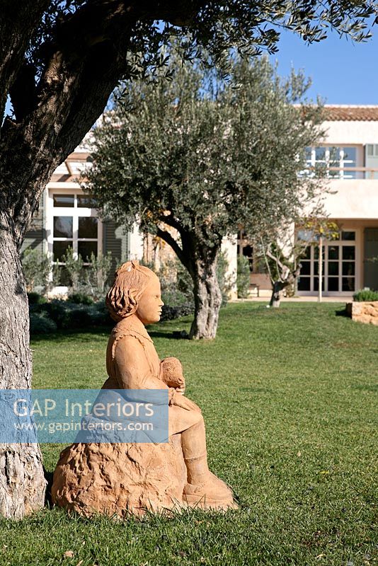 Terracotta sculpture under Olive tree