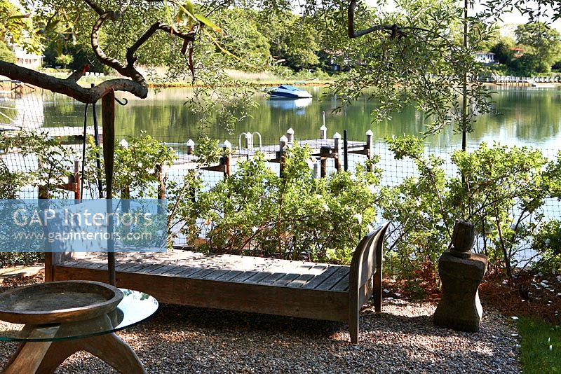 Daybed on patio by lake