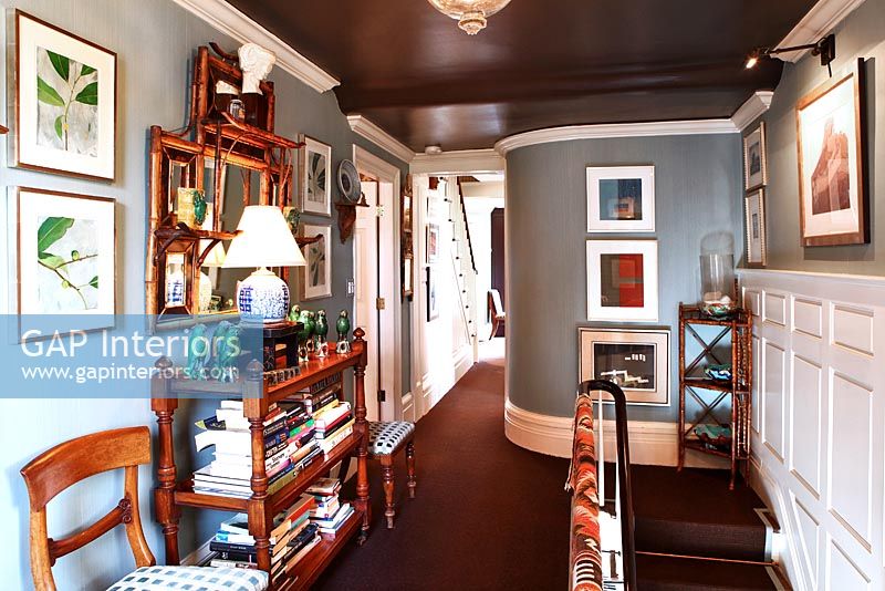 Classic landing with bookshelves and paintings