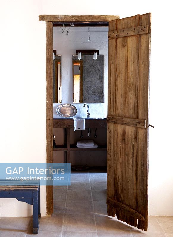 View of bathroom through wooden door