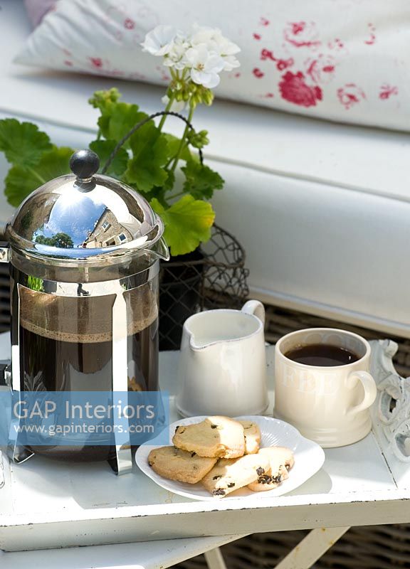 Coffee and biscuits on garden table