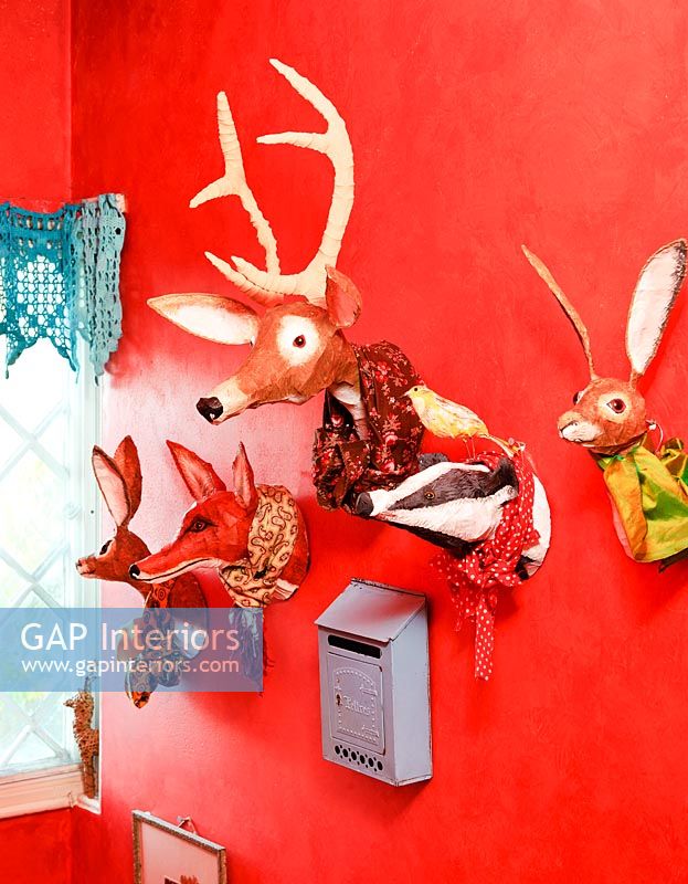 Kitsch ornaments mounted on red wall
