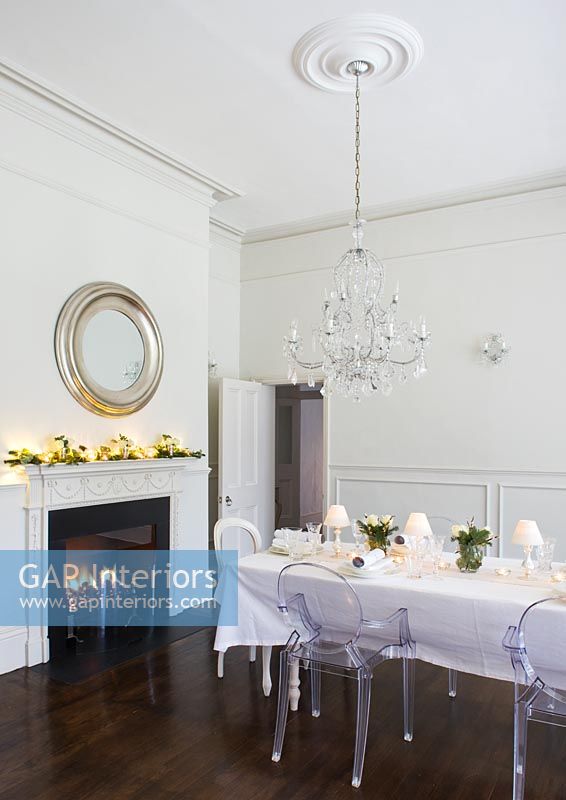 White dining room decorated for christmas meal