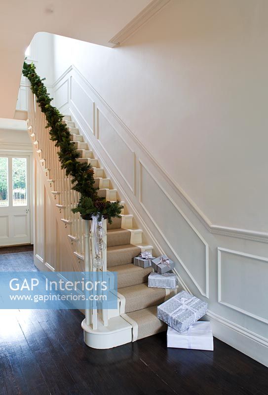 Classic hallway with christmas pine and cone garland