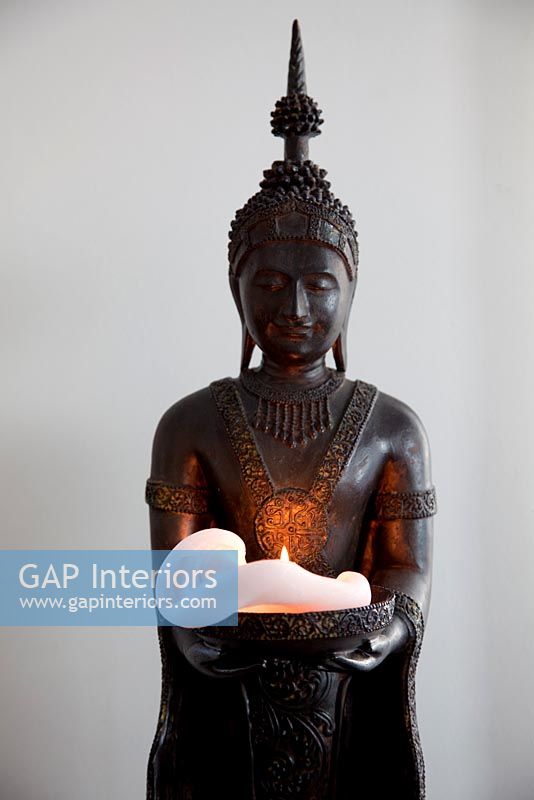 Asian statue and candle