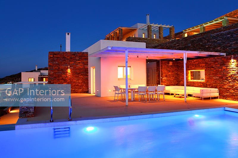 Villa and luxury swimming pool lit up at night