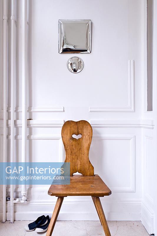 Antique wooden chair and contemporary mirrors