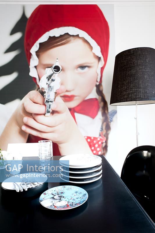 Contemporary dining room detail with 'Little Red Riding Hood Aiming Revolver' photo by Sandra Seckinger