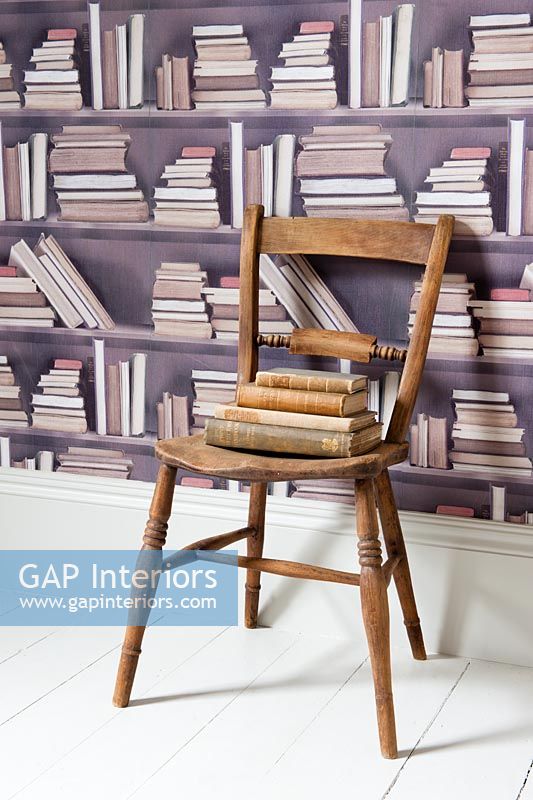 Wooden chair and patterned wallpaper
