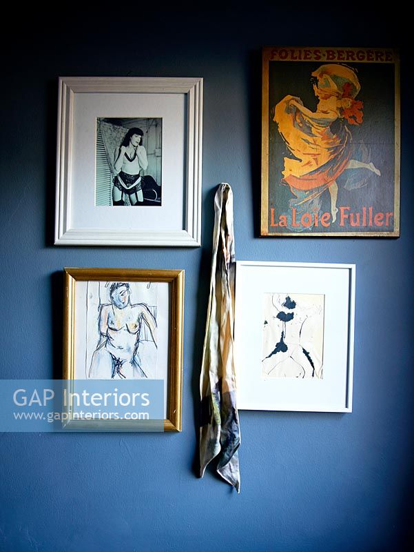 Life drawings and photos on black wall