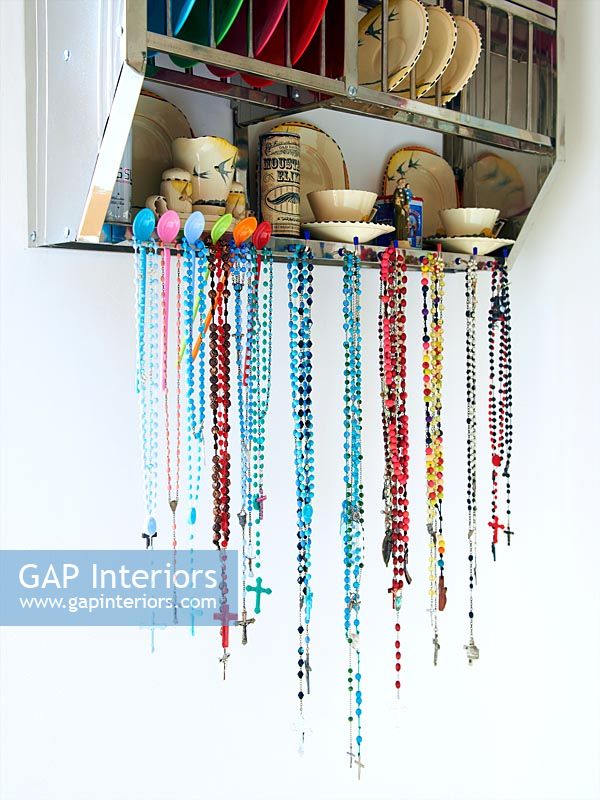 Beads hanging from metal plate rack