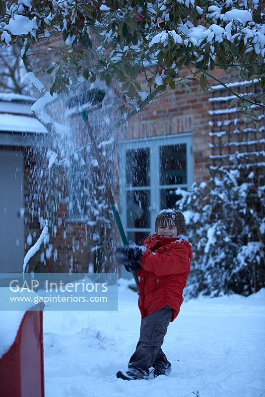 Boy playing in snow 
