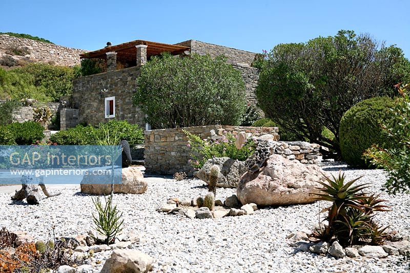 Traditional stone house and gravel garden

