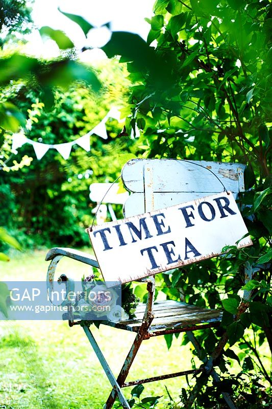 Time for tea sign on garden chair 