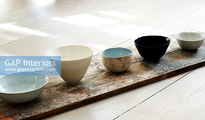 Ceramic bowl selection on wooden plank 