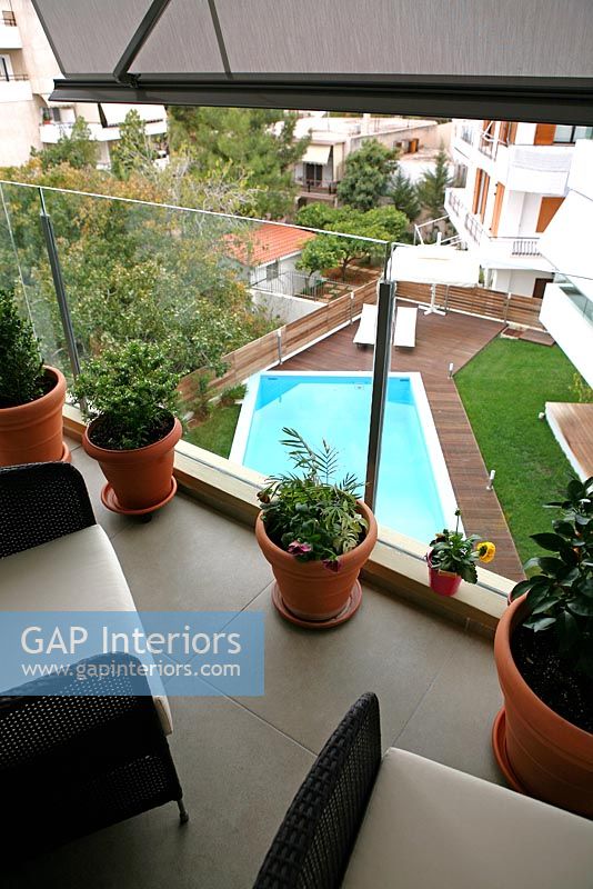 Modern balcony with view of swimming pool

