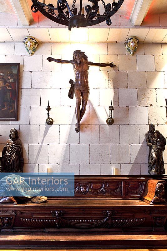 Statue of christ above carved wooden seating