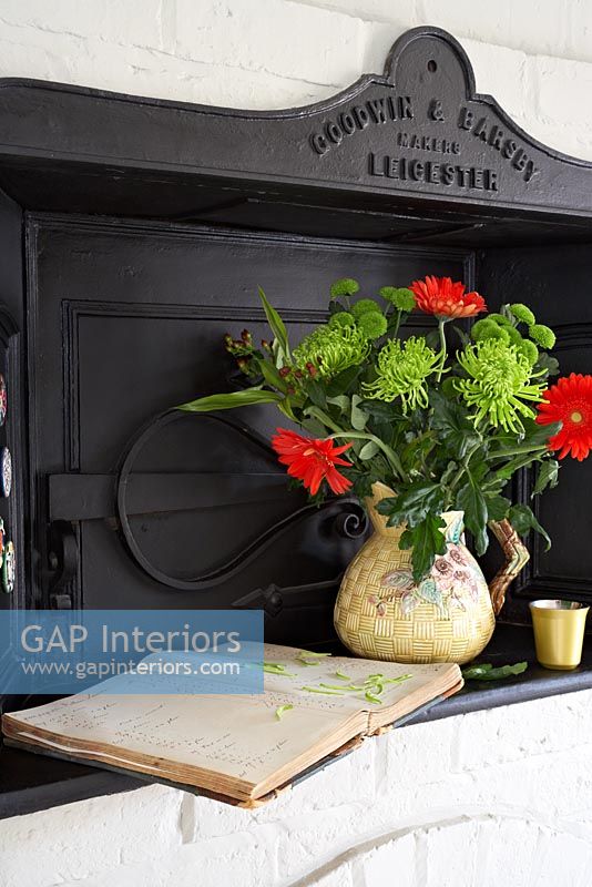 Colourful arrangement of Chrysanthemums and Gerbera flowers on bread oven