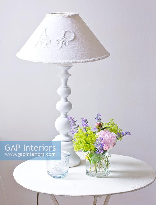 White lamp and flowers on vintage table