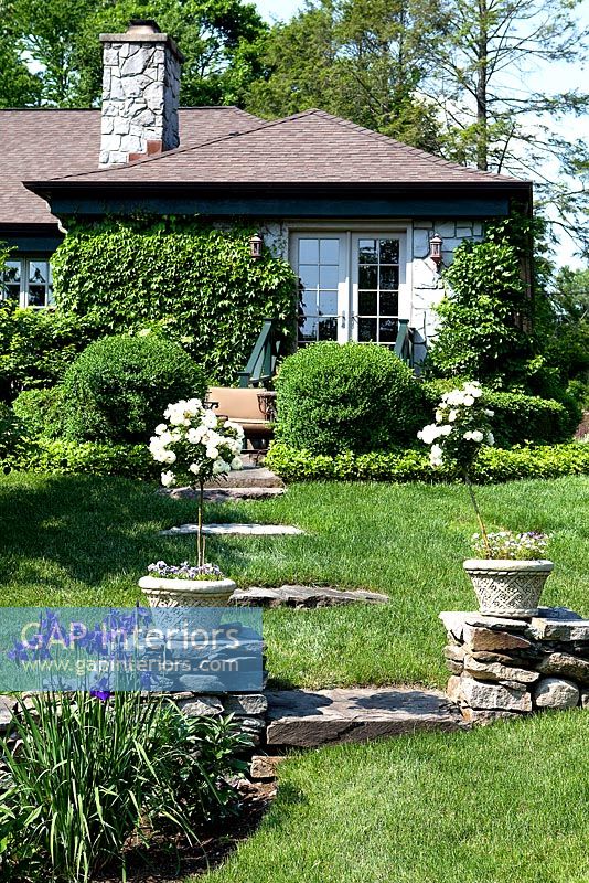 Stone cottage and garden with Roses and Irises
