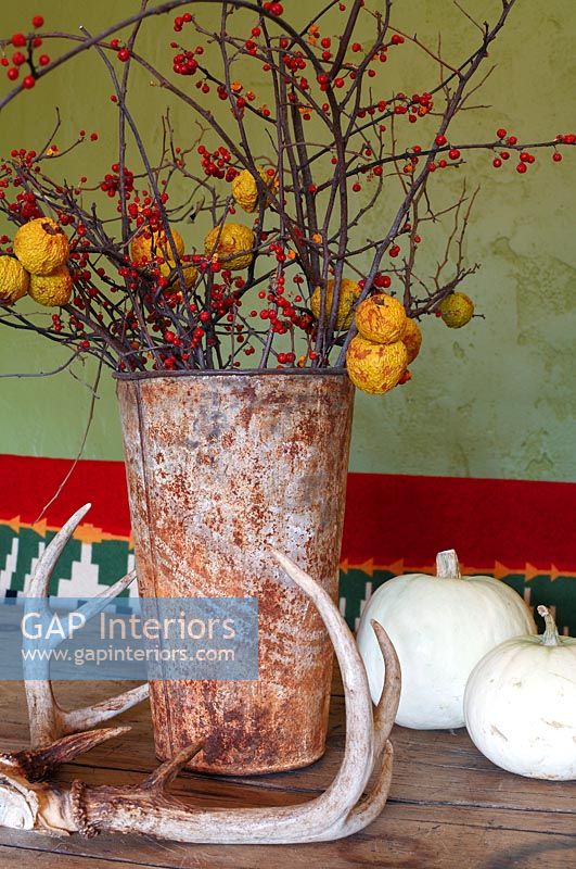 Arrangement of Crabapples and berries in rusty vase
