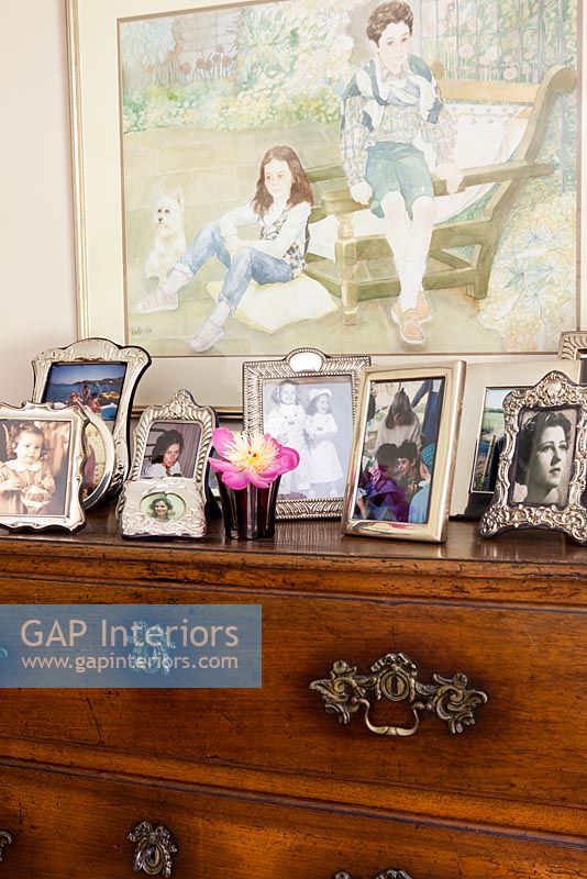 Family photos displayed on chest of drawers
