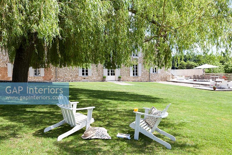 White chairs under Willow tree