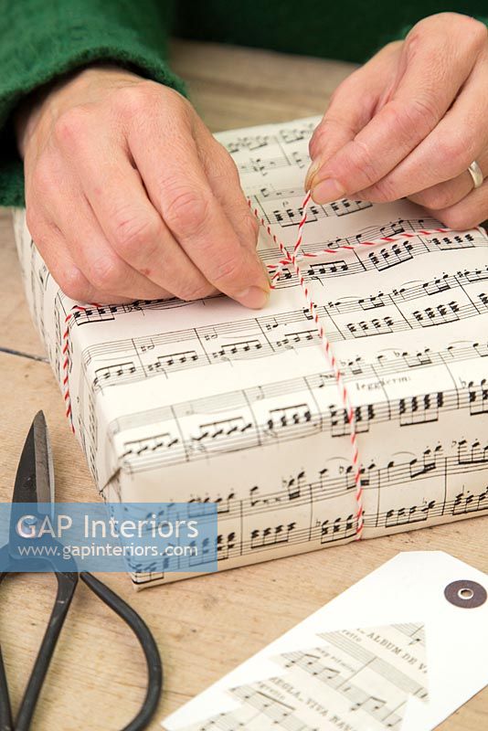 Wrapping Christmas presents with sheet music paper