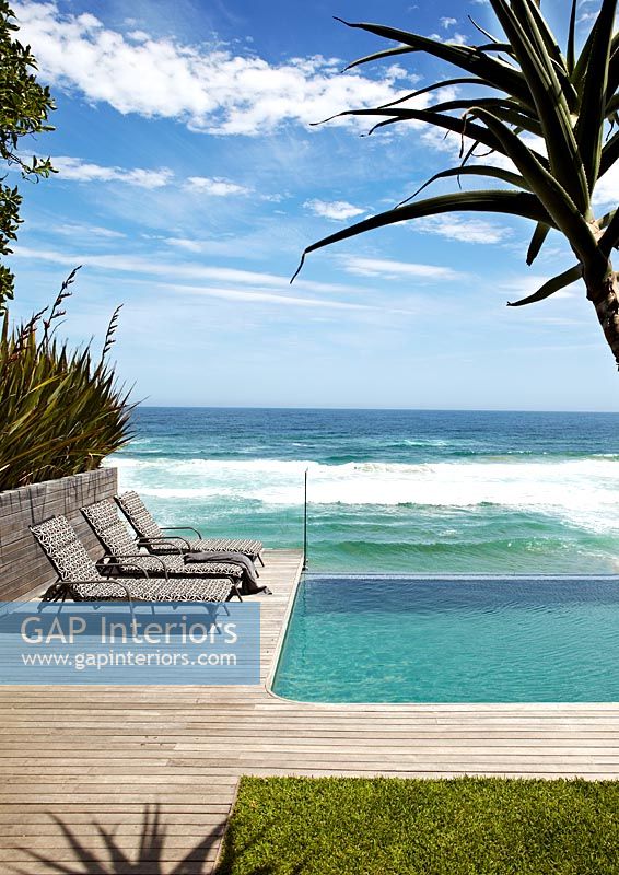 Contemporary infinity pool overlooking beach