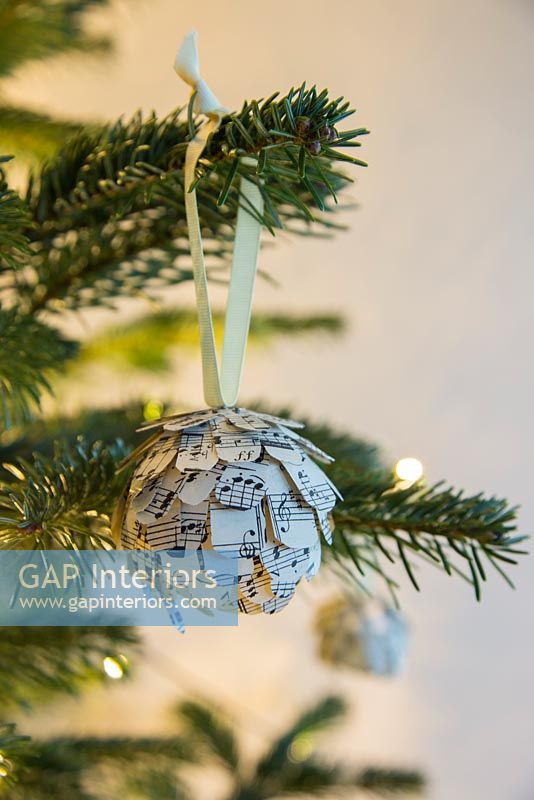 Step by Step guide for making paper cones using music sheet paper - finished bauble on tree
