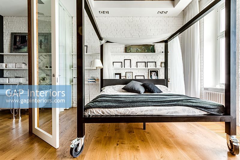 Modern four poster bed on casters