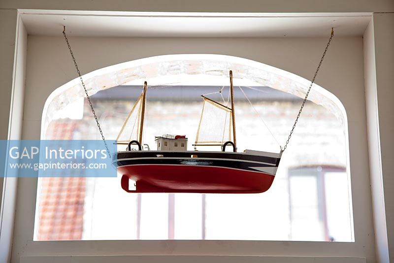 Model boat hanging at door