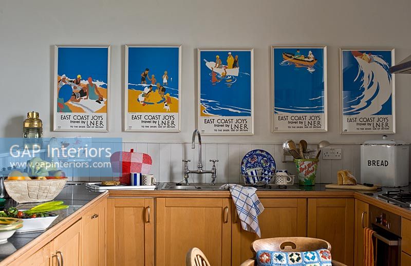 Colourful vintage  posters in kitchen