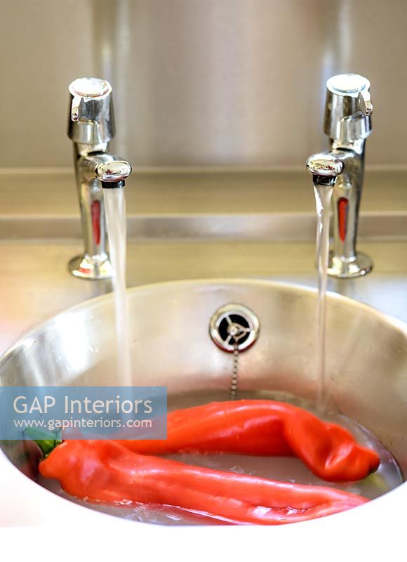 Rinsing vegetables in sink
